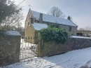 The church from the side road in early 2024